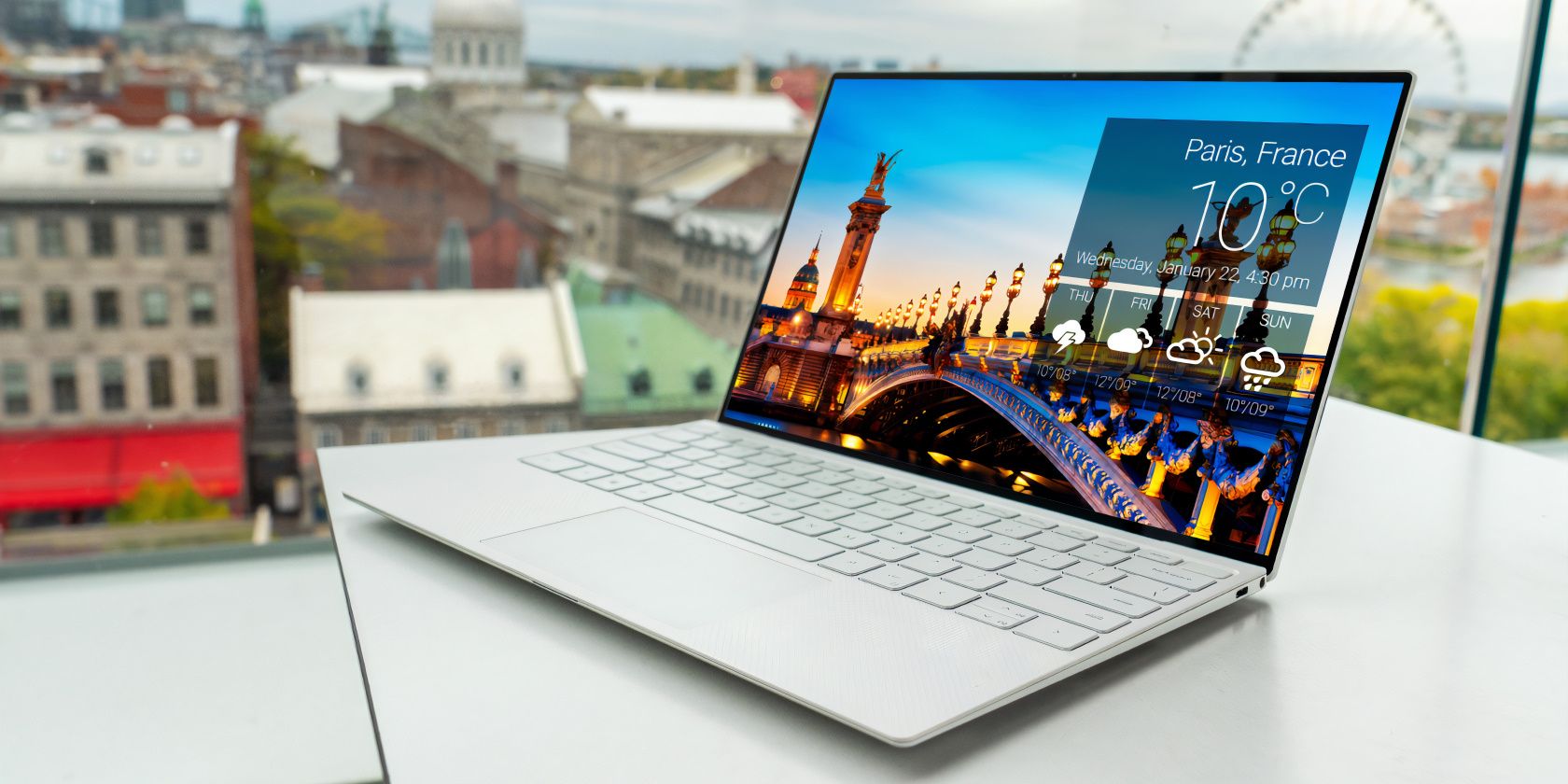 The laptop is placed on a white table