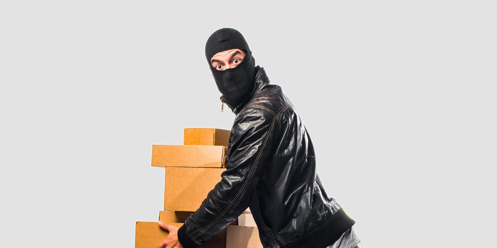 An illustration of a fraudster holding boxes